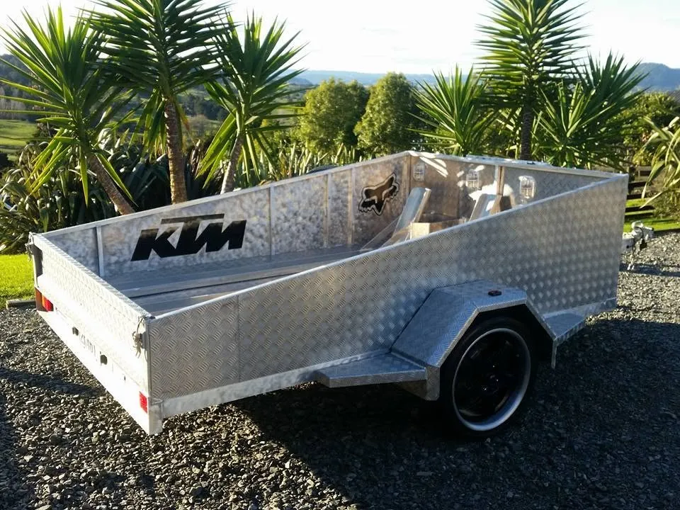 Metal utility trailer parked outdoors.